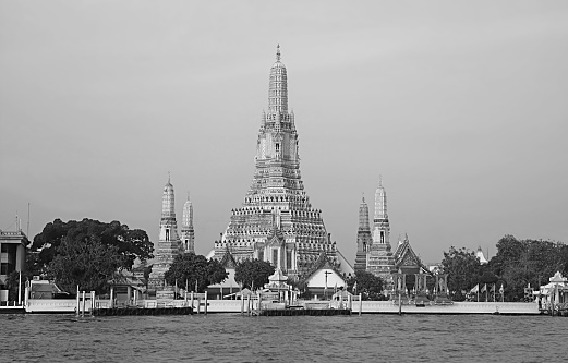 Fantastic Stupa of Wat Arun or the Temple of Dawn on the Chao Phraya River Bank, Historic Place in Bangkok, Thailand in Monochrome