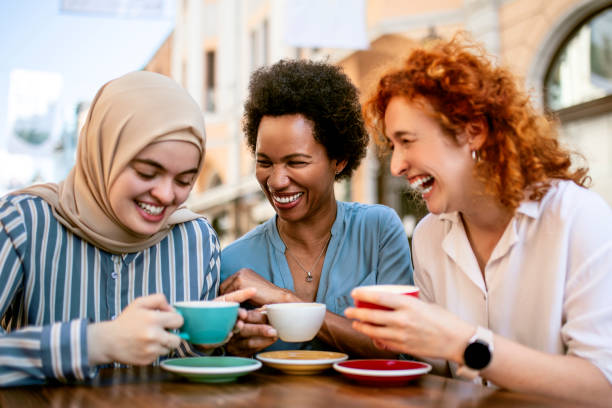 istock Multiethnic group of female friends drinking coffee talking having fun 1401736828