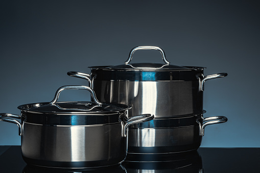 New cookware on black background, front view, copy space