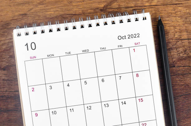 istock October 2022 desk calendar on wooden table. 1401739614