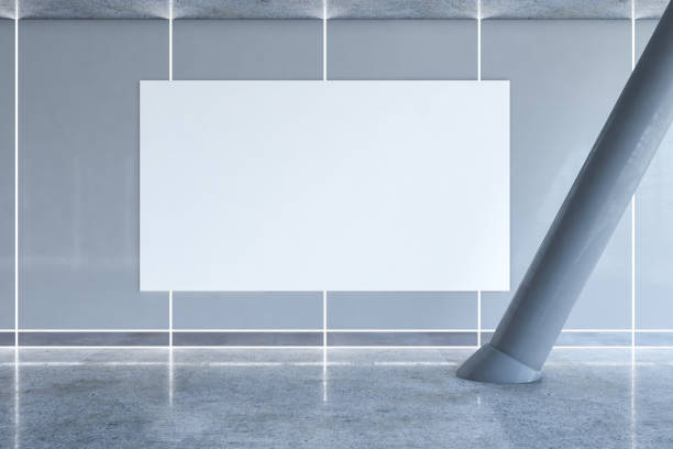istock Front view on big blank white banner with space for your logo or text on grey wall in empty sunlit business center hall with tilted column and glossy floor. 3D rendering, mockup 1401741407
