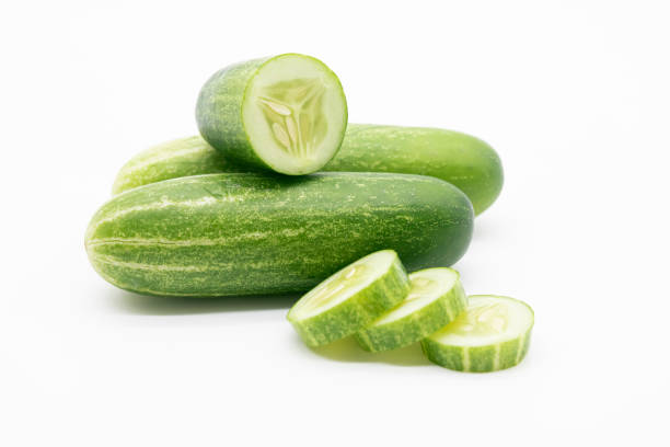 istock whole cucumber with some pieces isolated on white background.fresh vegetable for salad. 1401741726