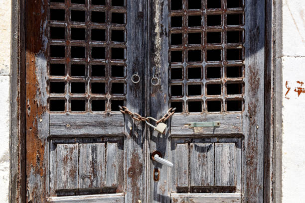 Ancient wooden door in the wall, brown. Texture