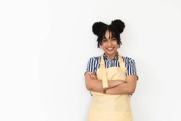 Studio portrait of a beautiful, happy young woman with apron