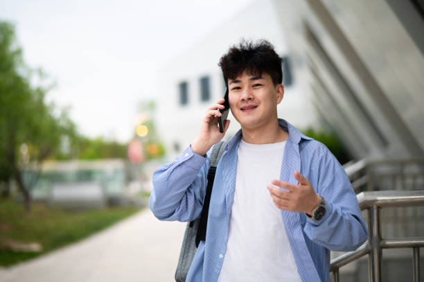 istock Asian young handsome man using smartphone at subway station 1401744669