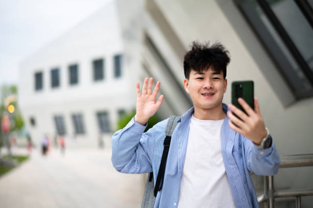 istock Asian young handsome man using smartphone at subway station 1401744692