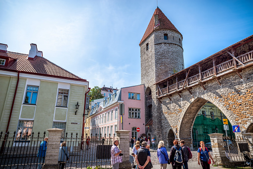 Tallinn, Estonia - August 5, 2019: tourists crossing the street in front of Nunna torn, Sauna torn and Kuldjala Torn (towers) outside the walls of Tallinn