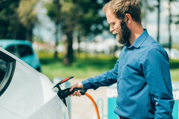 istock Man charging electric car 1401746017