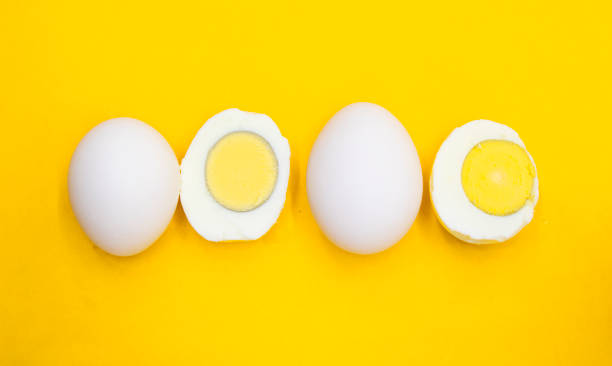 istock whole eggs and boil egg isolated on yellow background 1401747788