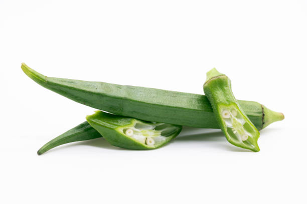 istock whole and pieces okra or Lady Finger over on white background, front view, selective focus 1401748031