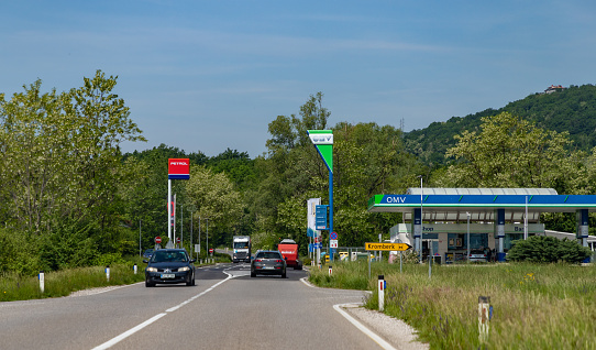 Ljubljana, Slovenia - May 11, 2022: A picture of two Slovenian gas stations, Petrol and OMV, on a countryside road.