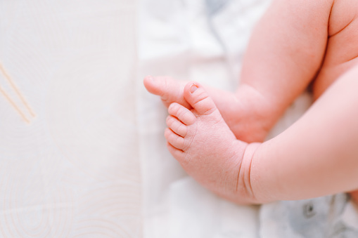 Newborn feet, innocence, maternity and babyhood concept