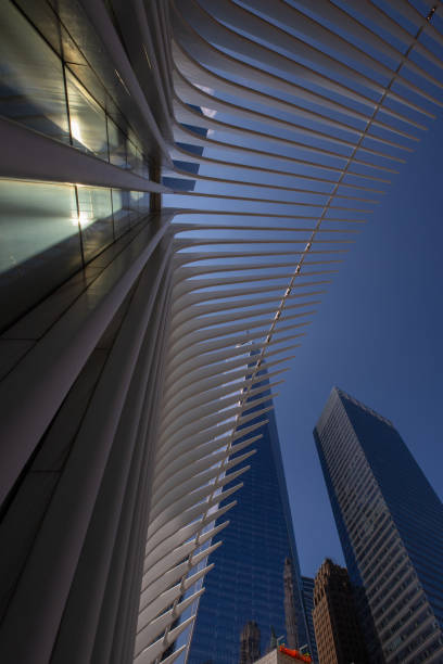 architectural ensemble in Manhattan, New York, United States. View of the Oculus and One World Trade Center. Beautiful blue sky and sun in the background. May 22, 2022. architectural ensemble in Manhattan, New York, United States. View of the Oculus and One World Trade Center. Beautiful blue sky and sun in the background. May 22, 2022. 2001 stock pictures, royalty-free photos & images