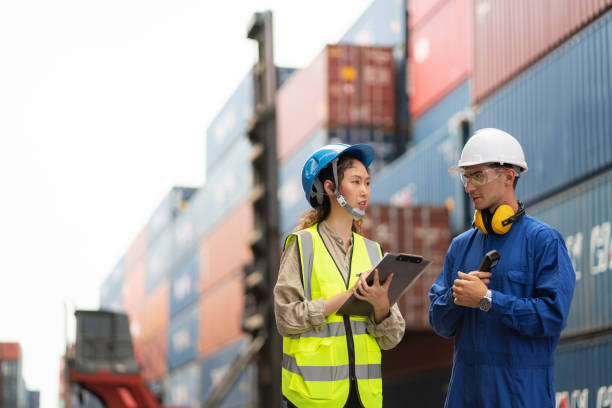 istock Dock manager and engineer worker in safety helmet discussing in shipping container yard with copy space. Import and export product. Manufacturing transportation and global business concept 1401753193
