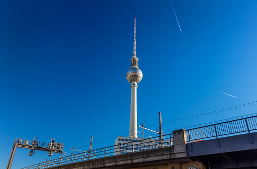 S-Bahn Elevated Railway line and airplanes flying past the Berliner Fernsehturm Television Tower, Berlin, Germany