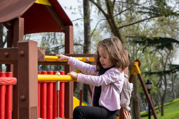 istock Girl climbing in the playground 1401756281