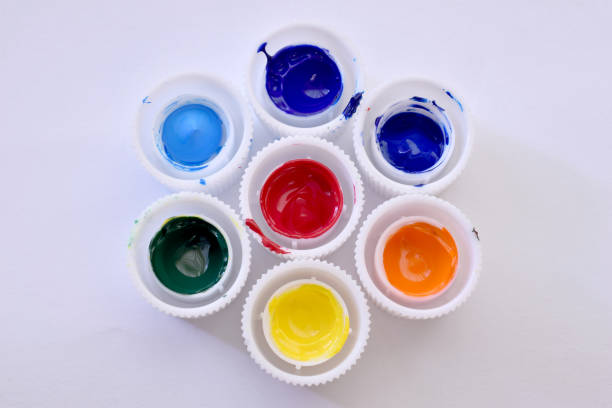 istock Different color caps from tubes of paint on white 1401759054