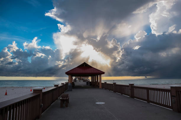 Clearwater Beach Pier with dramatic sky Pier 60 at Clearwater beach with dramatic sky. clearwater stock pictures, royalty-free photos & images