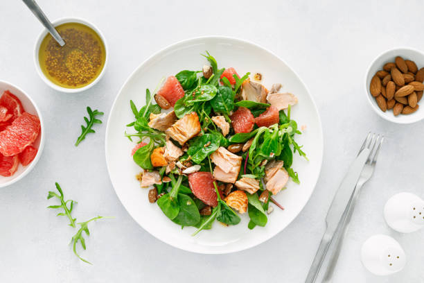 istock Grilled salmon salad with grapefruit, almonds and salad mix. Top view 1401761627