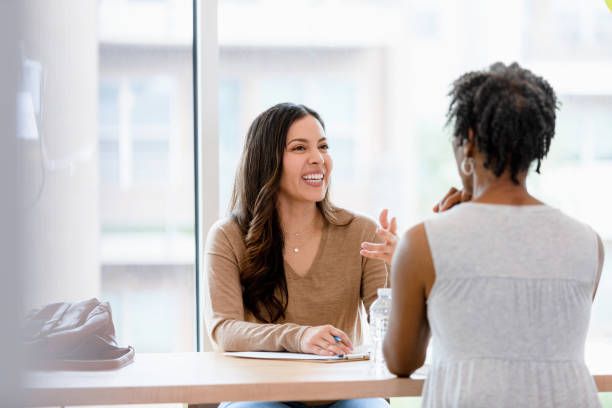 istock Female manager gestures and smiles while conducting interview 1401761839