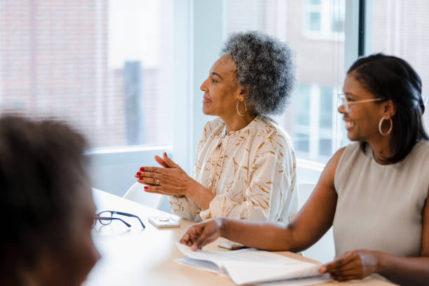 istock Women applaud for their new team member 1401762896