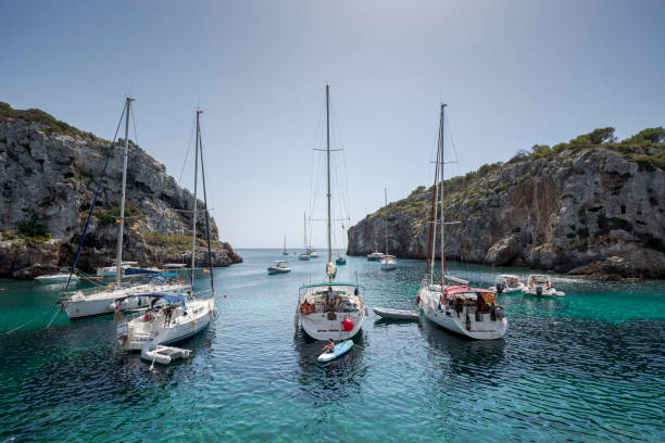 sailing boats anchored in cales coves - naval ship imagens e fotografias de stock