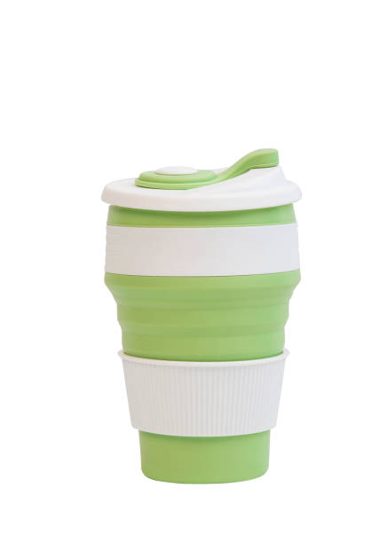 istock reusable green silicone cup. folding cup isolated on white background. replacement of plastic cup 1401764363