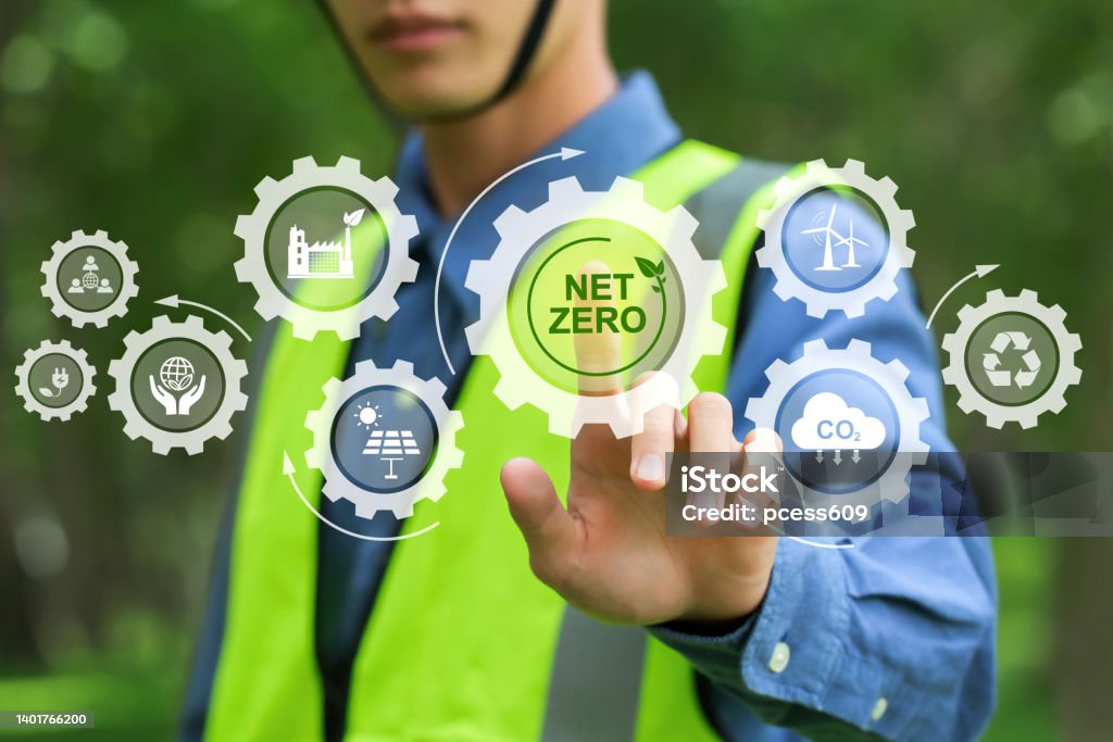 Net zero and carbon neutral concept.NET ZERO icons and symbols save the eco world and reduce pollution. environmental engineering touching green net zero icon and green icon on a green background. Net zero and carbon neutral concept.NET ZERO icons and symbols save the eco world and reduce pollution. environmental engineering touching green net zero icon and green icon on a green background."n Construction Industry Stock Photo