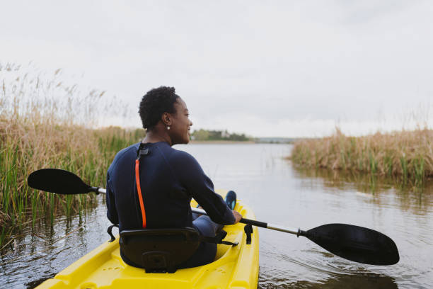 istock Young woman kayaking on the lake 1401767568