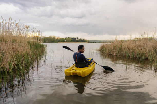 istock Young woman kayaking on the lake 1401768146