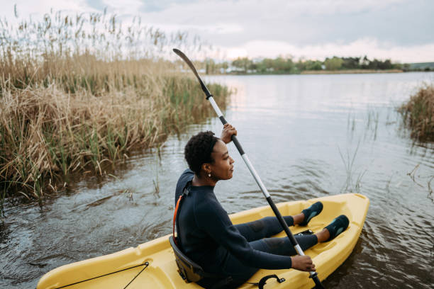 istock Young woman kayaking on the lake 1401768264