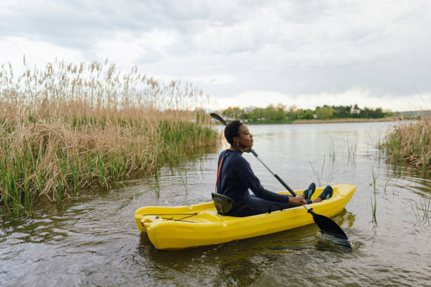 istock Young woman kayaking on the lake 1401768336