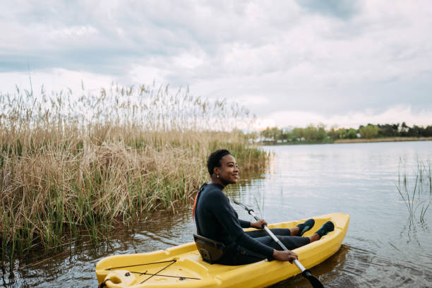istock Young woman kayaking on the lake 1401768375