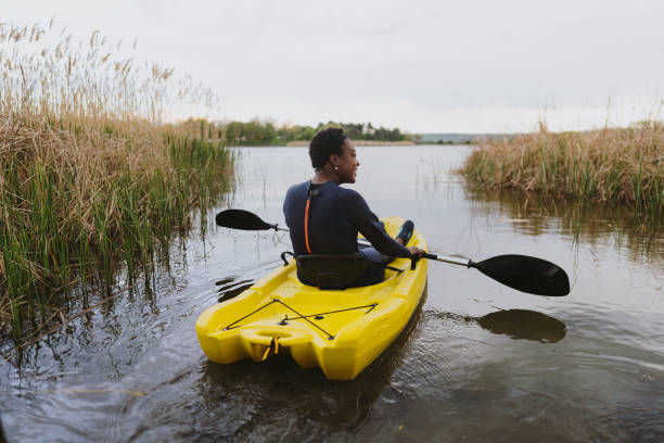 istock Young woman kayaking on the lake 1401768412
