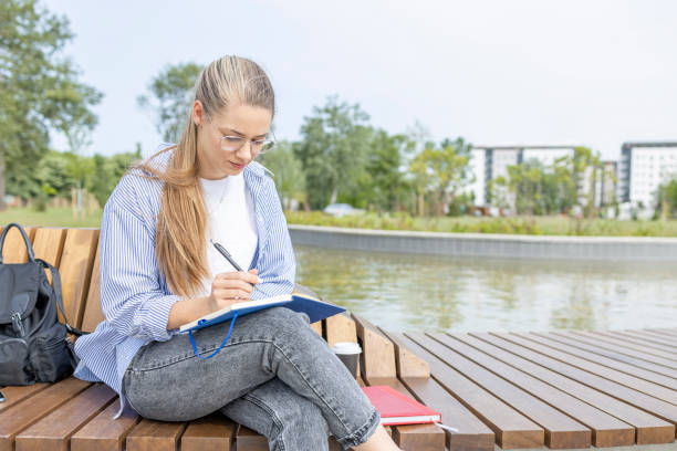 istock Female student learning for exams outdoors 1401768839