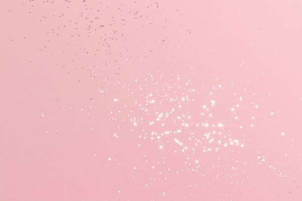 istock Sparkling silver glitter on pink background 1401769000