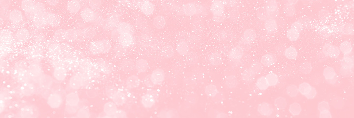 Pink sparkling glitter bokeh background, banner texture. Abstract defocused lights header. Wide screen wallpaper. Panoramic web banner with copy space for design