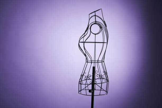 Elegant black dress with white collar hanging on clothes rack isolated over white