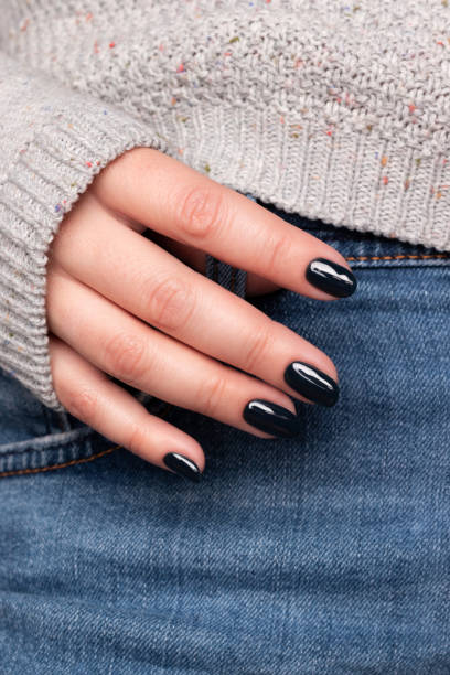 istock Hand with dark black nails on jeans 1401769381
