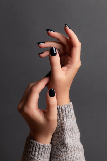 istock Female hands with black nails 1401769402