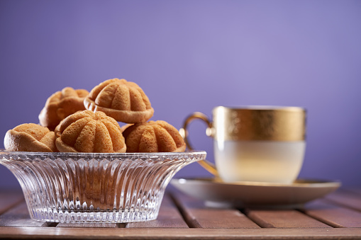 Kuih Bahulu - tradiditonal Malay cake.mini sponge cake with cup of tea