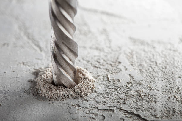 istock drill bit make holes in concrete wall with industrial drill. Building work industry. 1401770627