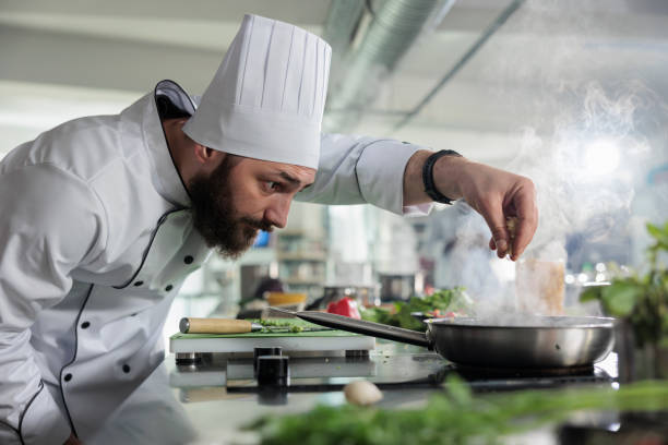istock Food industry worker preparing ingredients for evening meal in professional kitchen 1401772028