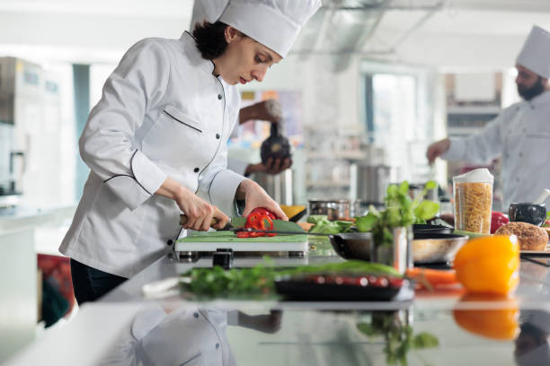 istock Sous chef chopping red pepper vegetable for gourmet dish served at dinner in restaurant 1401772100