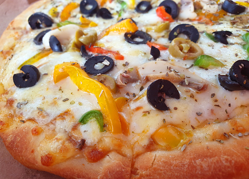 delicious vegetable pizza with melted mozzarella cheese