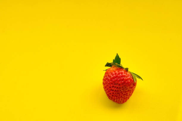 Set of strawberries on a yellow background.