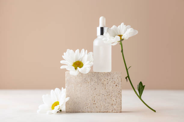 istock Cosmetic serum bottle on travertine stone podium. Minimal mockup background. 1401773464