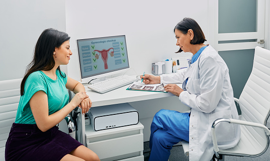 Consultation of gynecologist. Doctor and woman patient is talking in gynecological office during visit at gynecology office