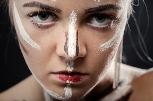 female portrait with professional face art paint cosmetics