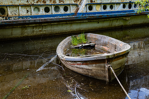 old rotten sunken boat tied to the shore. High quality photo